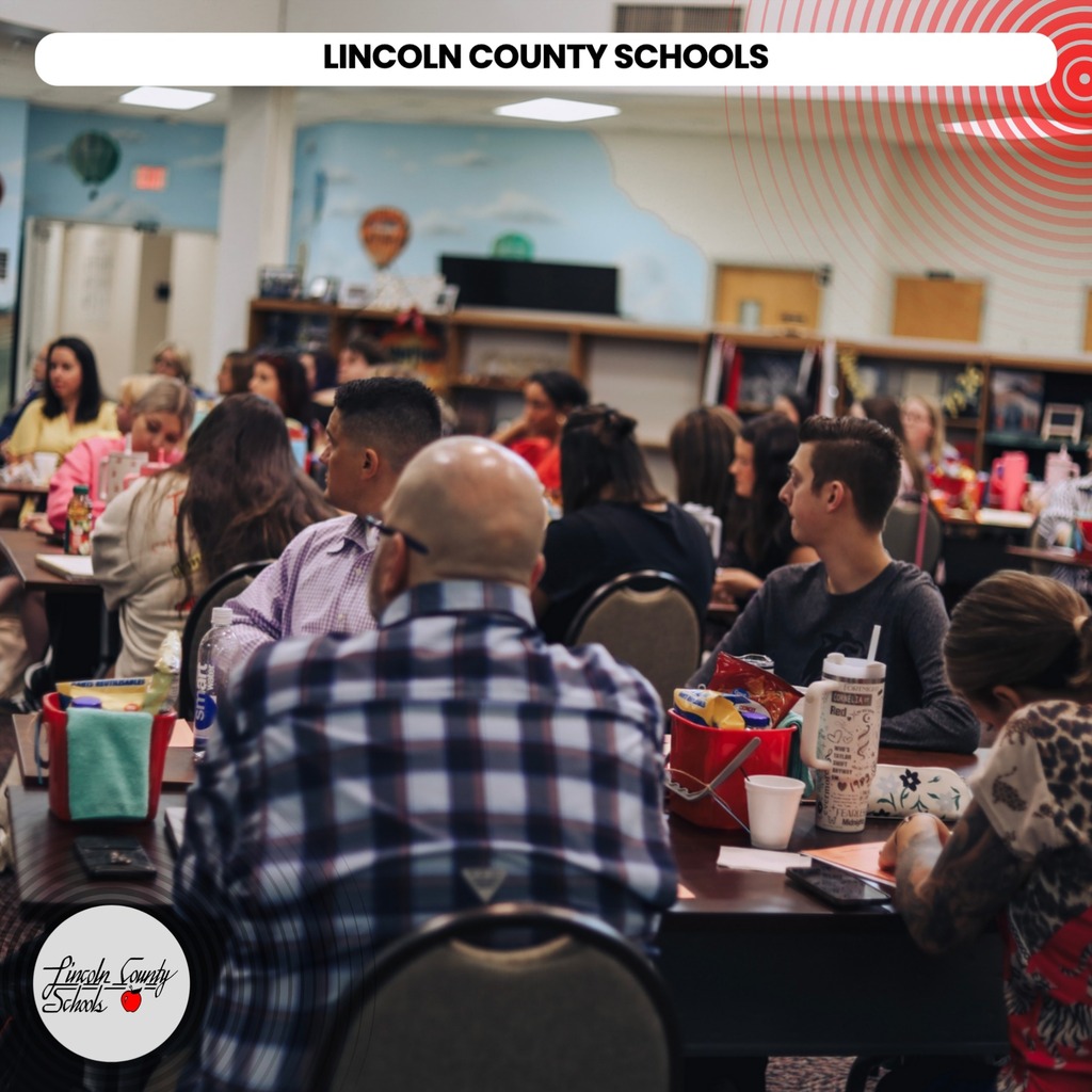 Attendees are seated at tables inside a room. Most are focused on eating. The top has a watermark that reads "LINCOLN COUNTY SCHOOLS".