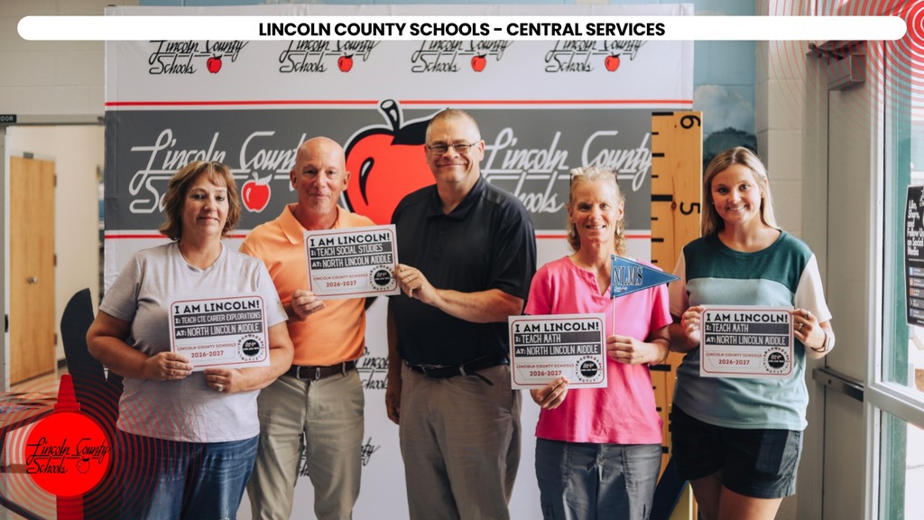 Five people stand together holding certificates in front of a Lincoln County Schools banner.