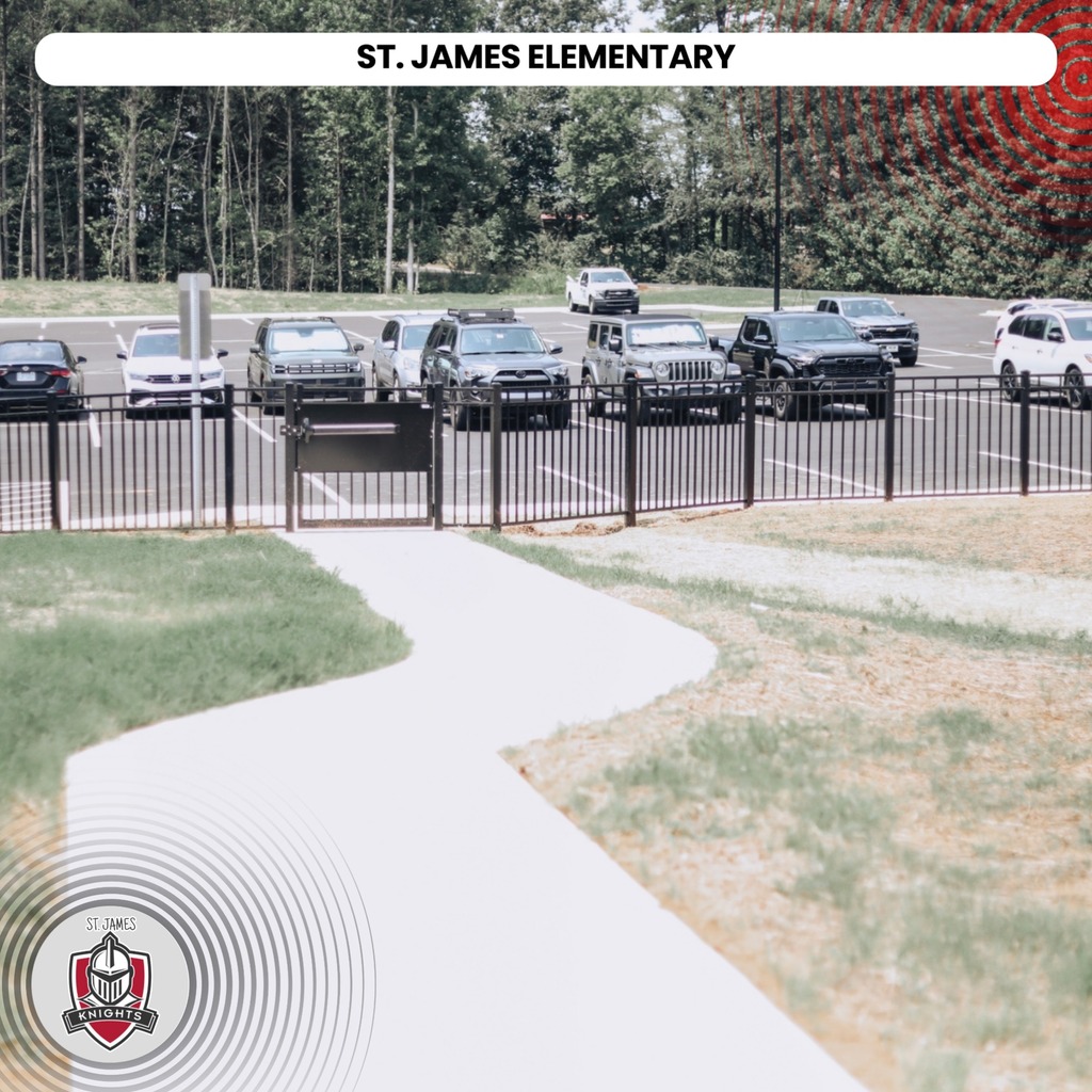 Parking lot with cars parked, black fence, grassy area, trees in background. "ST. JAMES ELEMENTARY" in top center.