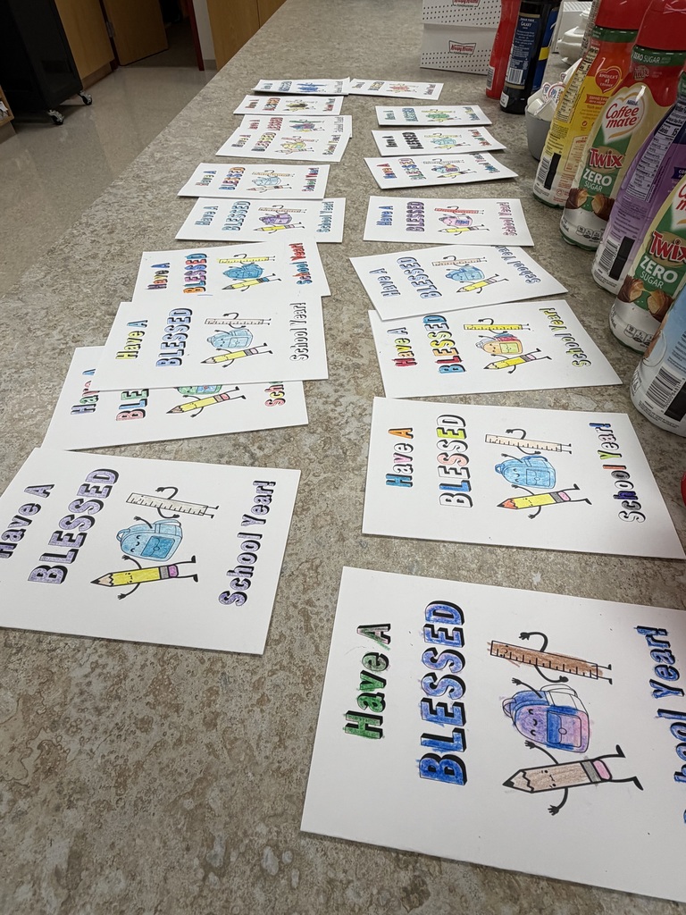 A table displays colorful cards with illustrations and text such as "Have a Blessed Year" and "Blessed" on a marble surface.