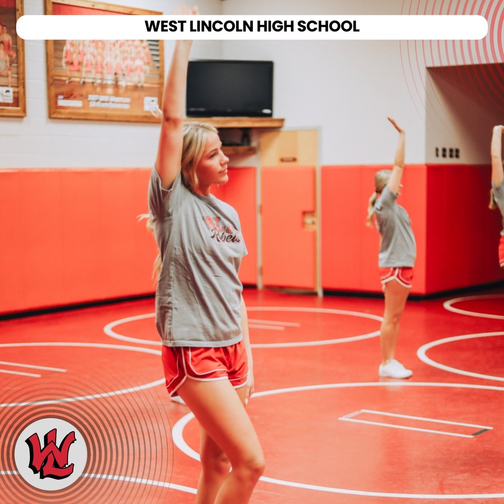 Three individuals in matching shirts and shorts performing exercises in a gym. Background includes a red wall and orange floor.