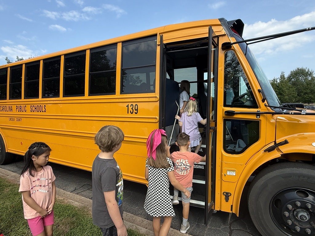 Students learning about bus safety and how to be a leader on the school bus.