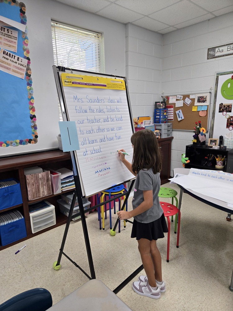 Mrs. Saunders class signs their class mission statement  
