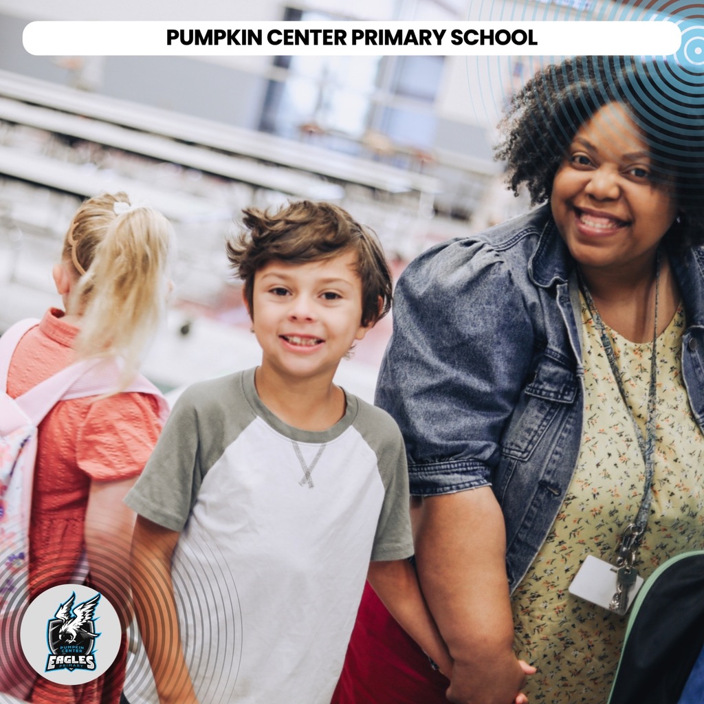 A woman and two children in a hallway at Pumpkin Center Primary School. One child is wearing a necklace.