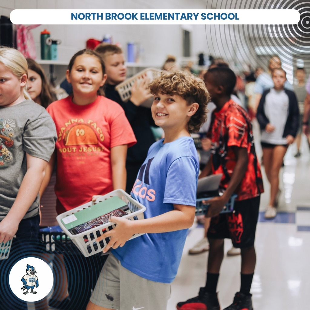 A group of children at North Brook Elementary School, one holding a basket. They are standing in a hallway.