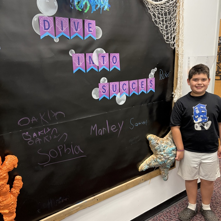 Boy at black board in a black shirt