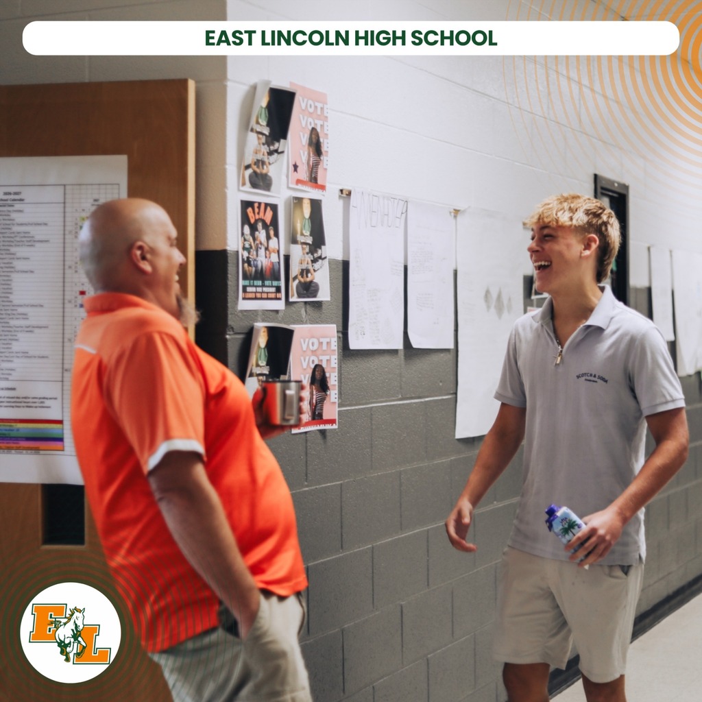 Two males in a hallway, one in orange and one in gray, stand and converse. Text at top reads "EAST LINCOLN HIGH SCHOOL".