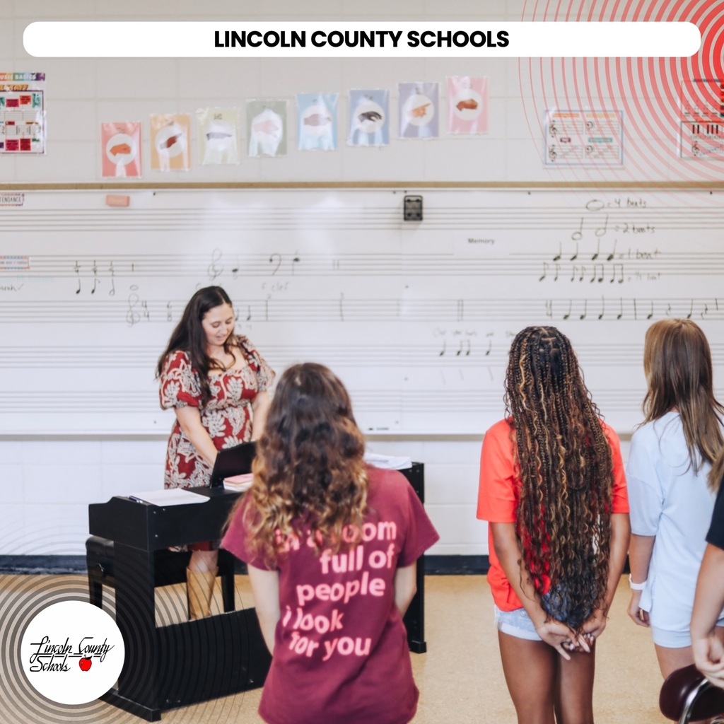 A classroom with students and a teacher. Students face away from the camera. Text reads "Lincoln County Schools."