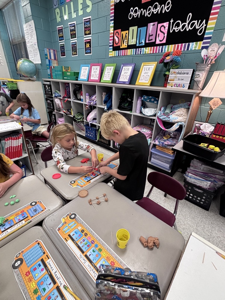 Students working together to build 3D shapes out of Play-Doh.