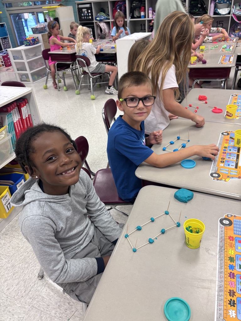 Students use Play-Doh and toothpicks to building models of 3D shapes.