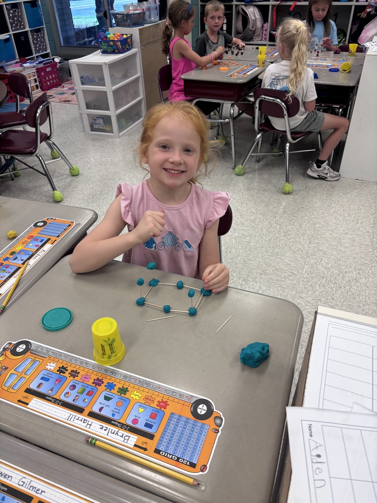Students use Play-Doh and toothpicks to building models of 3D shapes.