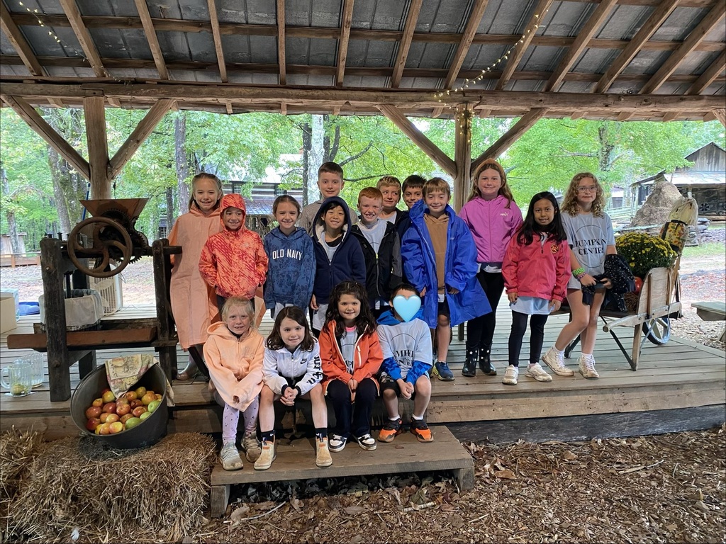 Students learning how to make apple cider on their field trip to Hart Square