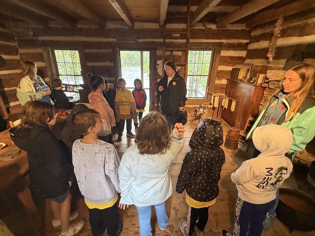 Students touring cabins on their field trip to Hart Square