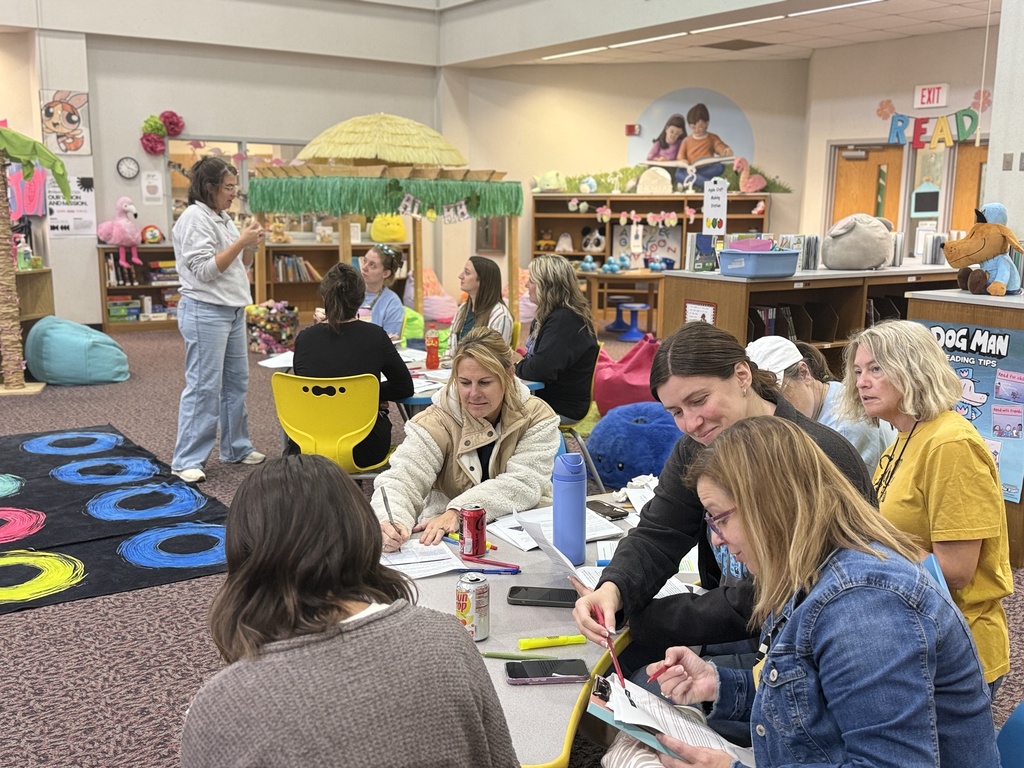 Staff participating in a professional development during monthly staff meeting.