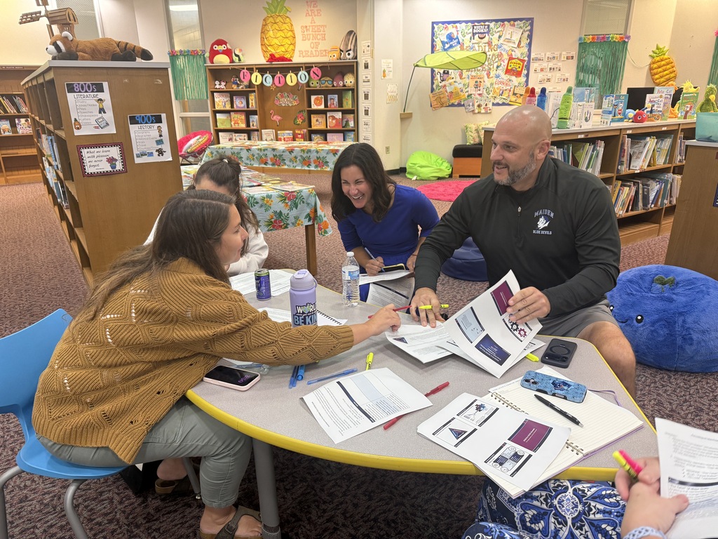 Staff participating in a professional development during monthly staff meeting.