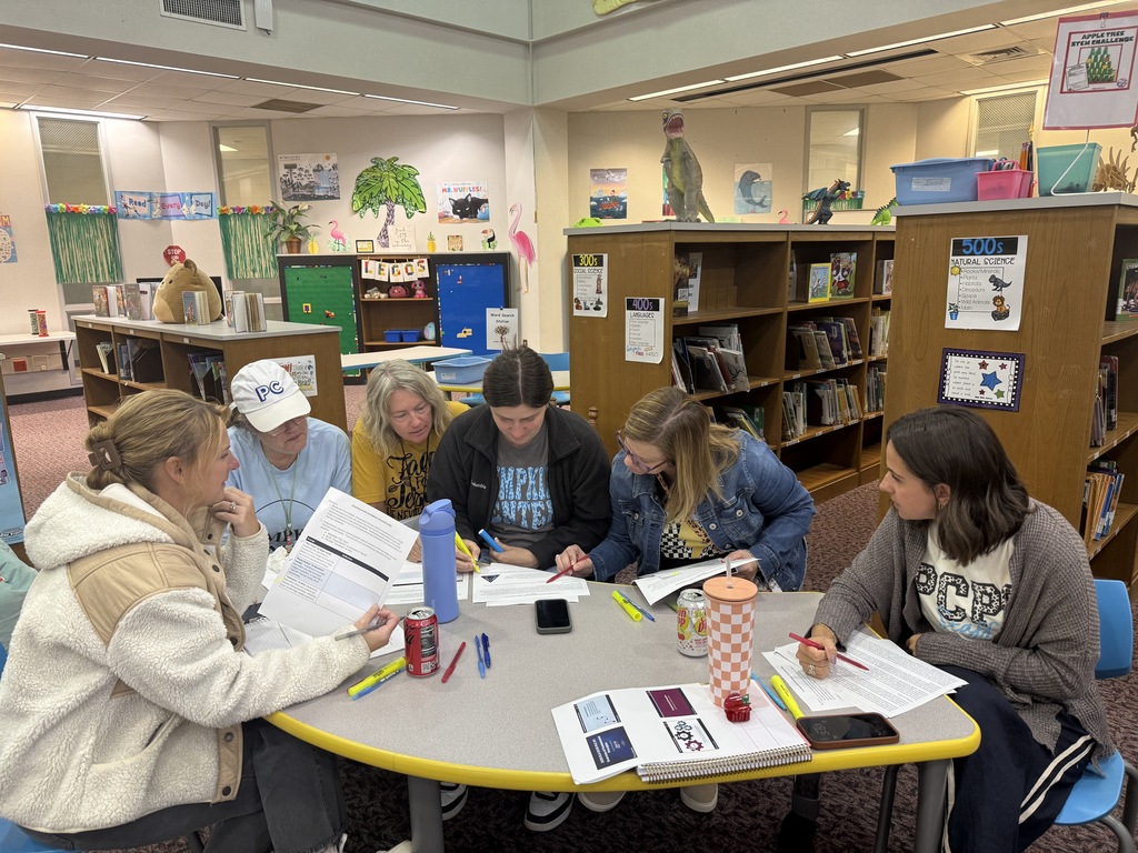 Staff participating in a professional development during monthly staff meeting.