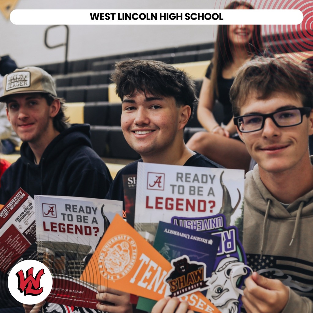 Four male students holding signs with the text "Ready to be a legend?" in a school setting.