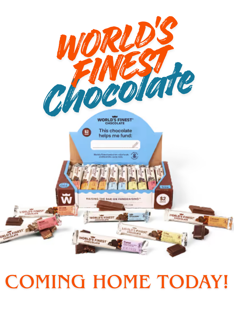 Advertisement for "World's Finest Chocolate" featuring a display box and assorted chocolate bars with "Coming Home Today!" text.