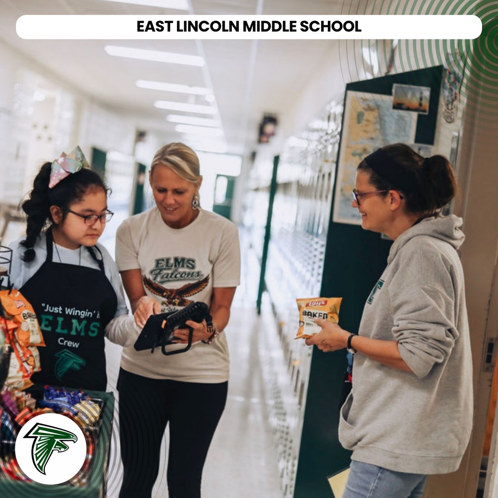 Three women in a school hallway, one holding a tablet and two talking. Background includes lockers and a map.