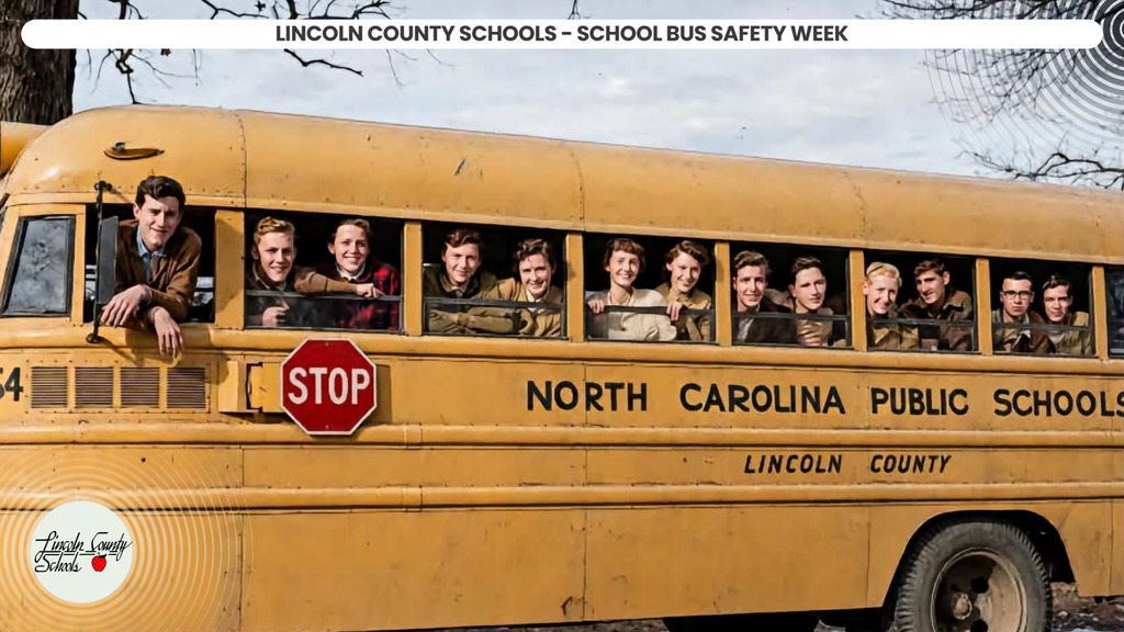 Yellow school bus with students inside, one leaning out window, stop sign on front.