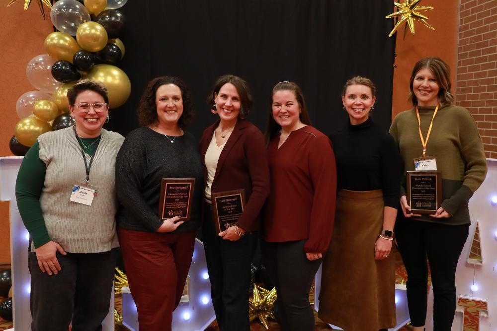 A group of six Lincoln Public Schools counselors stand together at the Nebraska School Counselor Association conference.