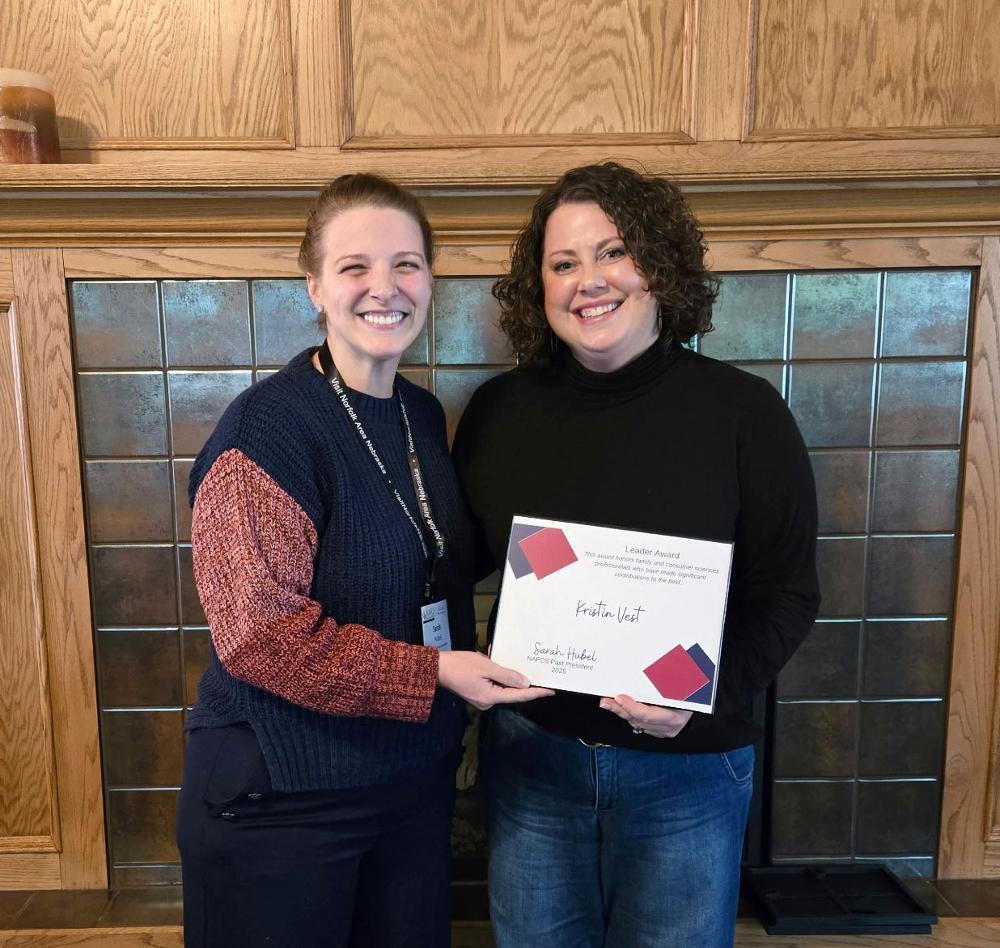 From left, Nebraska Association of Family and Consumer Sciences Past President Sarah Hubel presents Kristin Vest with the NAFCS Leader Award. Vest is the FCS curriculum coordinator at Lincoln Public Schools.