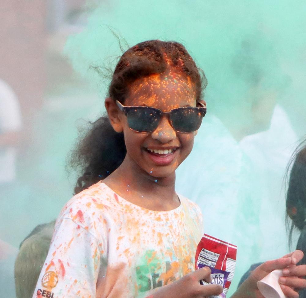 Arnold Elementary School fifth grader Santana smiles toward the camera during the Arnold Color Run.