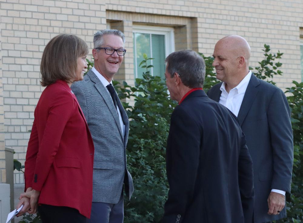 Superintendent John Skretta smiling as he talks with Lincoln Mayor Leirion Gaylor Baird, Governor Jim Pillen, and ALLO Fiber representatives at a Smart Schools broadband event.