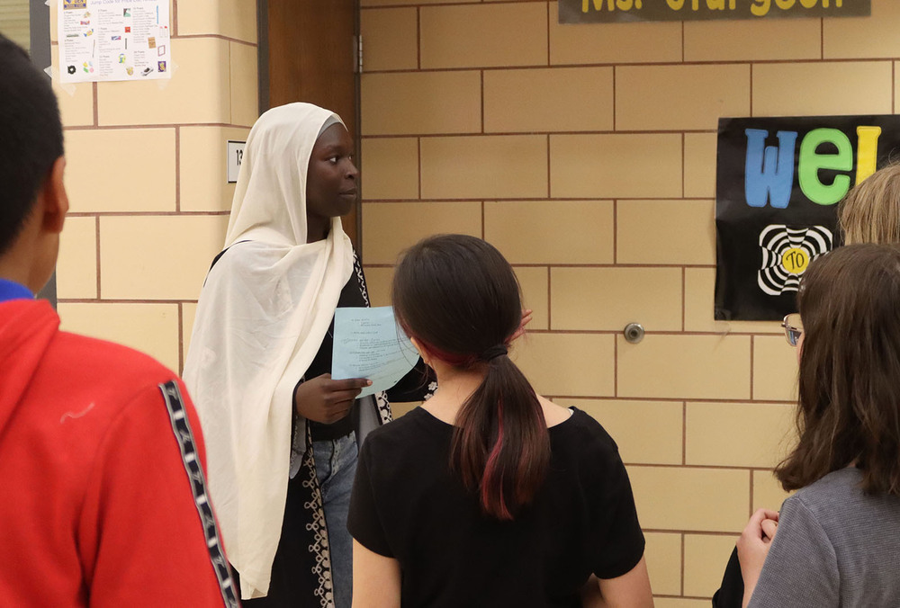 A Park Middle School eighth grader shows several Everett Elementary School fifth graders the entrance to Park's art classroom during a tour of the building.