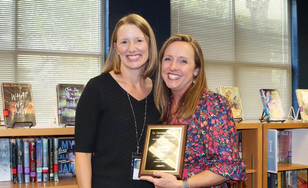 From left, Nebraska School Librarians Association President Joy Harvey smiles with LPS Director of Library Information Services Lori Haeffner after Haeffner received a state honor.