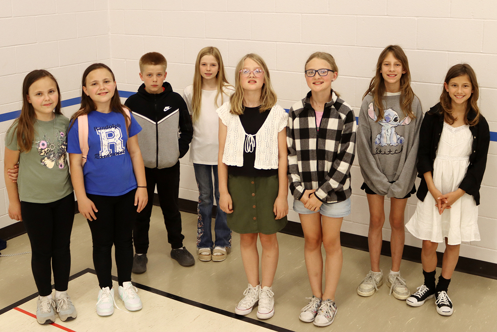 Four sets of twins graduated from fifth grade at Randolph Elementary School this spring. From left, Aurea and Kitty, Seth and Summer, Ashlynn and Brynlee and Rose and Caroline smile in the school gym.