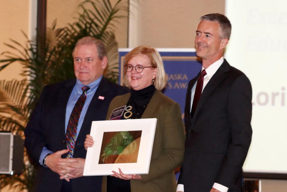 LPS Visual Art Curriculum Specialist Lorinda Rice is smiling in between two representatives of the Nebraska Art Education Association.