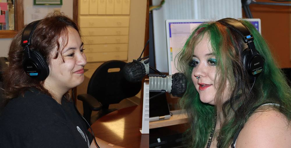 From left, Bay High Focus Program seniors Ella and Hazel smile during their "Groove Lagoon" radio program. They are sitting in front of microphones at the KZUM broadcast studio. Ella is facing left to right and Hazel is facing right to left.