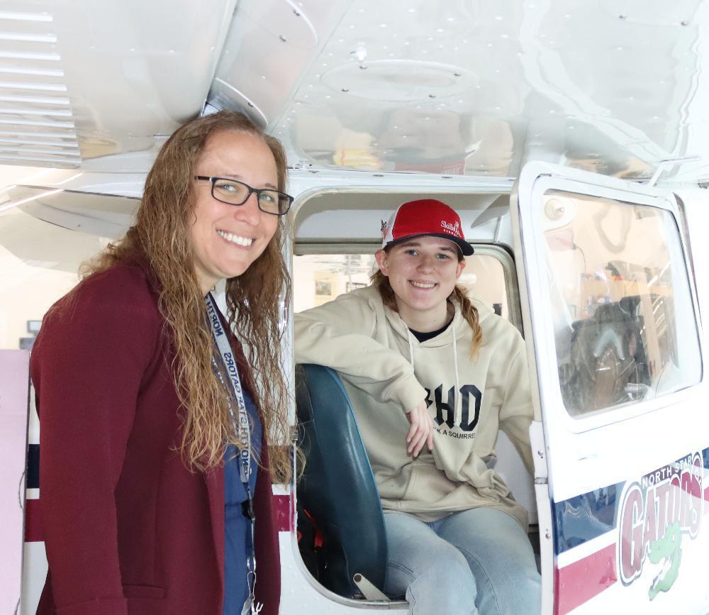 From left, North Star High School Principal Megan Kroll smiles with a student in the school's aviation program.