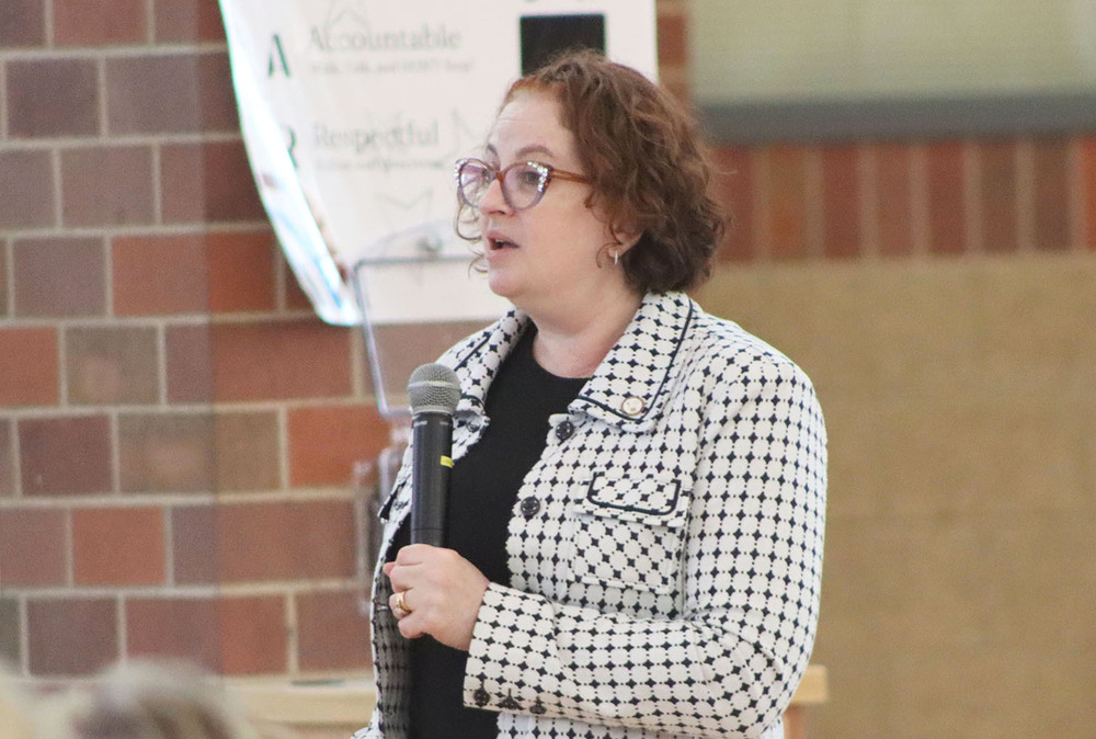 Stephanie Leite presents her research about autism to a full room of LPS administrators and school resource officers.