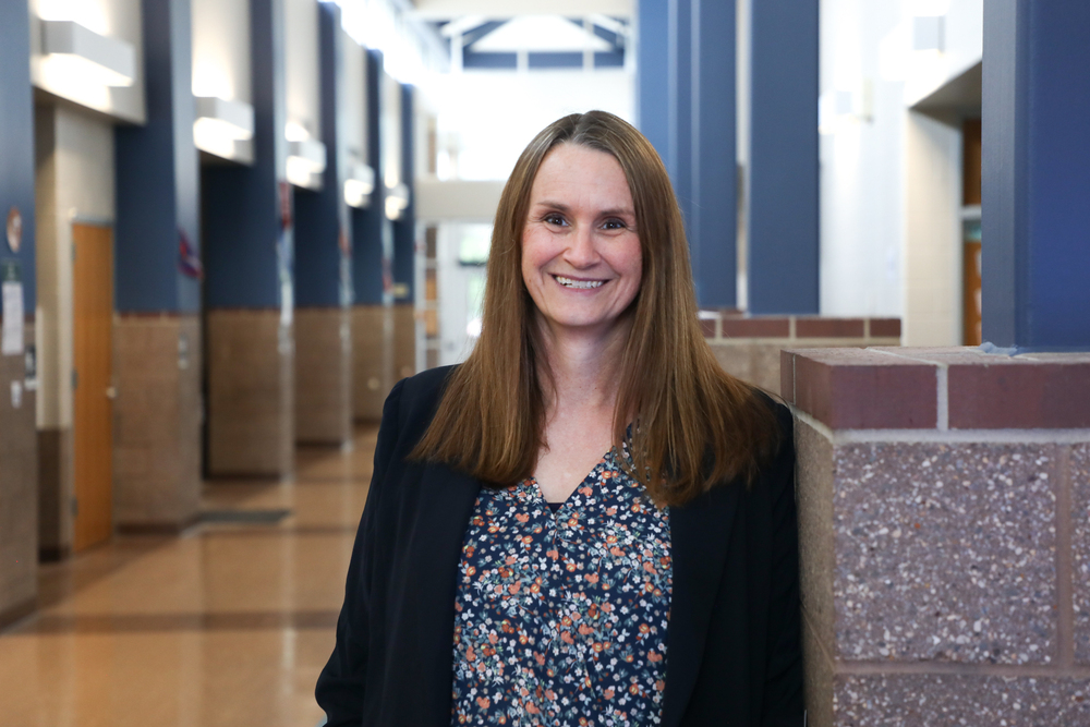 woman standing in school hallway