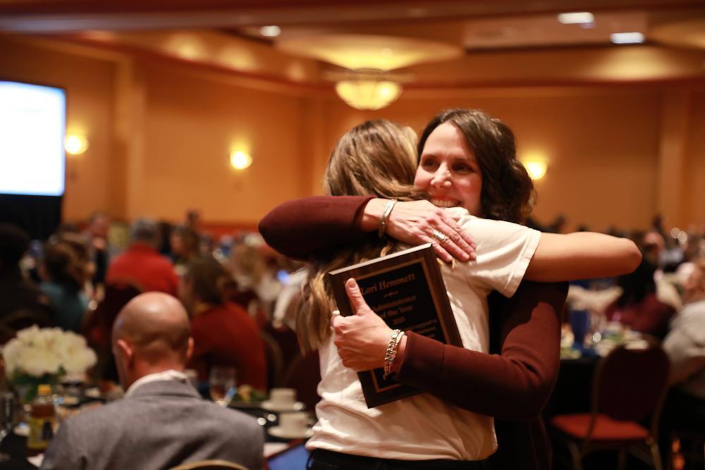 LPS School Counseling Supervisor Lori Hemmett embraces a colleague at the NSCA Annual Awards Luncheon.