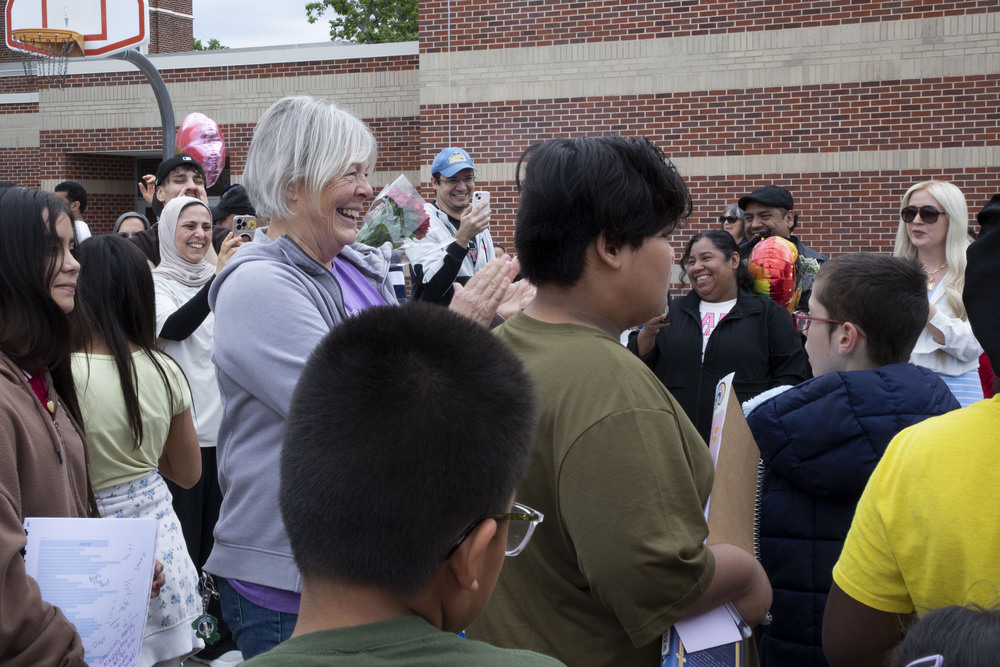 Elliott Elementary Fifth Grade Teacher Rhonda Mueller claps for a student on the school’s outside basketball court.