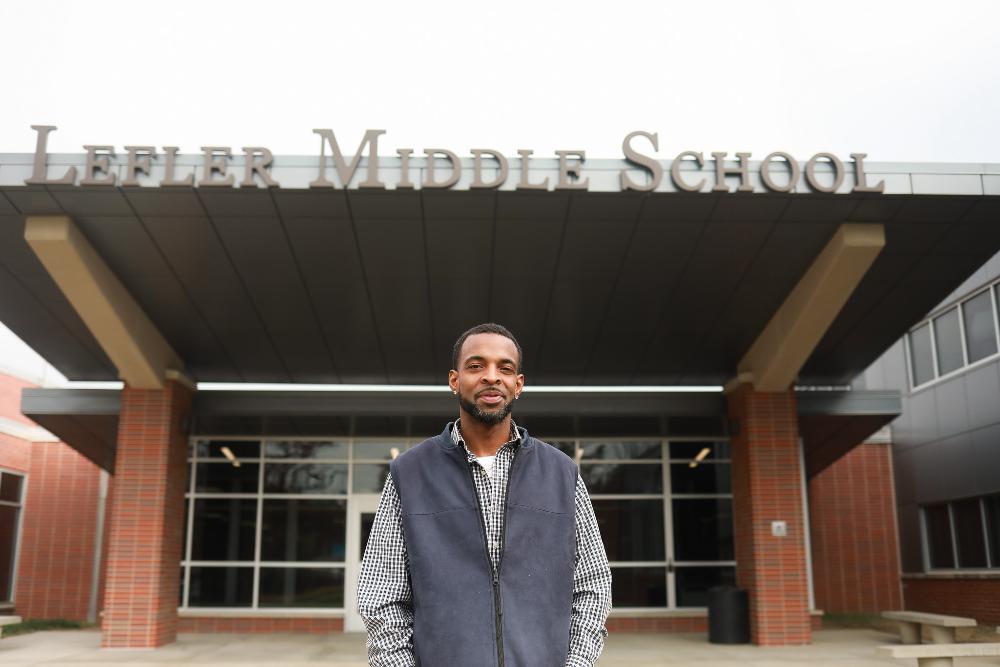 A man standing outside a school.