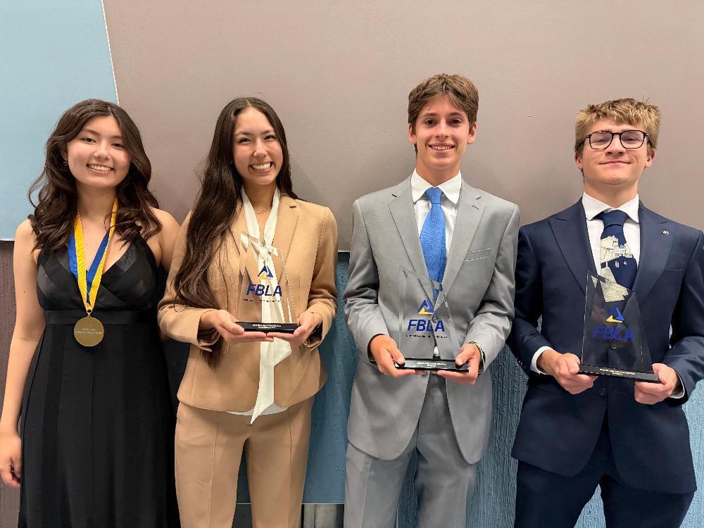 From left, East High School students Annabelle Kumm, Emily Kumm, Brad Bobaru and Konnor Garrett smile with their awards at the 2025 Future Business Leaders of America National Leadership Conference. Annabelle Kumm became the 2025-26 national parliamentarian, Emily Kumm placed third in the Introduction to FBLA contest, Bobaru placed fifth in the UX Design event and Garrett placed second in the Economics contest. Students from East, North Star, Southeast and Southwest qualified for the national event.