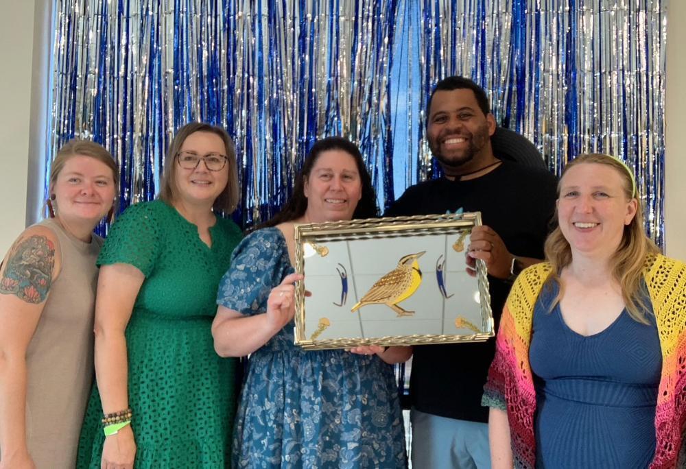 Five Lincoln Community Learning Centers staff members smile with the inaugural Place Matters Pioneer Award at a celebration event this summer.