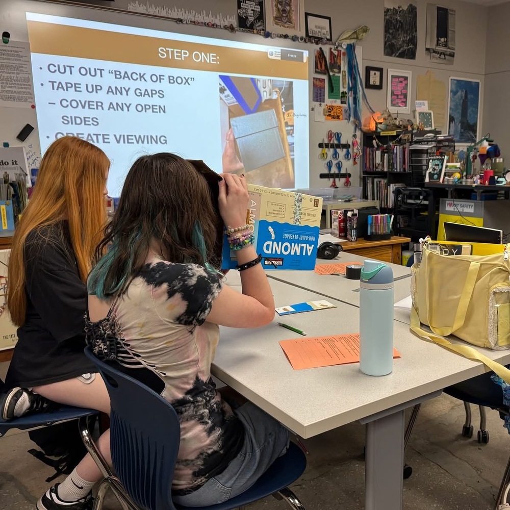 Four students building a camera obscuras
