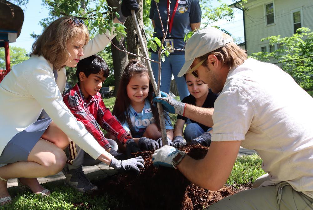 From left, Lincoln Mayor Leirion Gaylor Baird works with Hartley Elementary School students Saharsh, Abrar and Fatima to plant a tree at Hartley Park this spring. The three Hornets met with Gaylor Baird to talk about their ideas for improvements at the neighborhood park. They penned a letter to the mayor’s office this past winter for a persuasive writing assignment in their English Learner class.