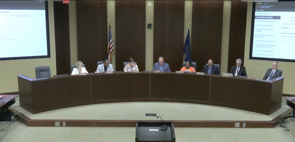 Six Lincoln Board of Education members sitting in the Board room at the dias with superintendent John Skretta and legal council Derek Aldridge.