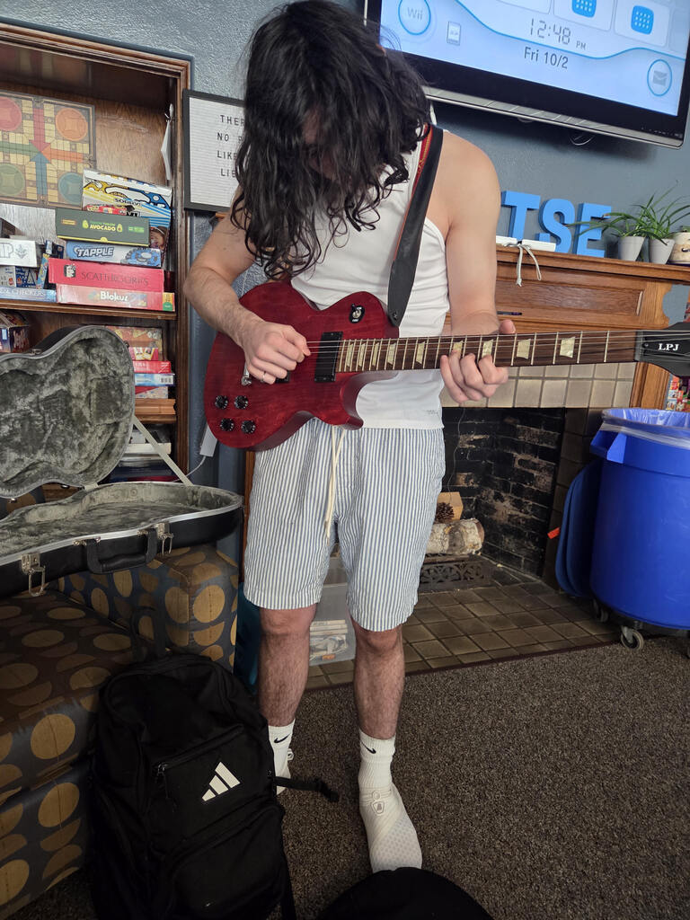A student plays guitar