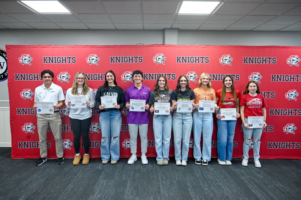 student athletes posing for a photo in front of a LWC backdrop