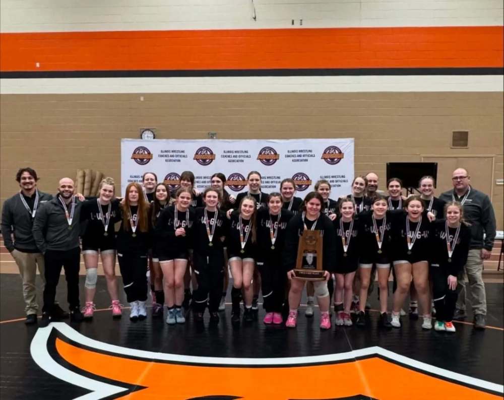 LWGW team posing for a photo with their state title trophy