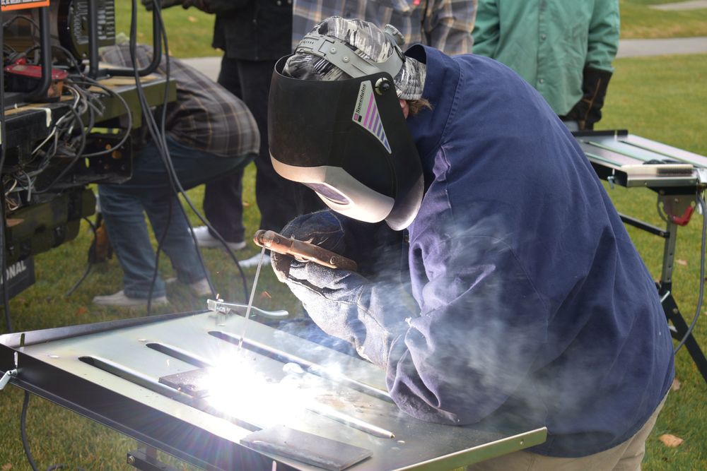 Students welding outside