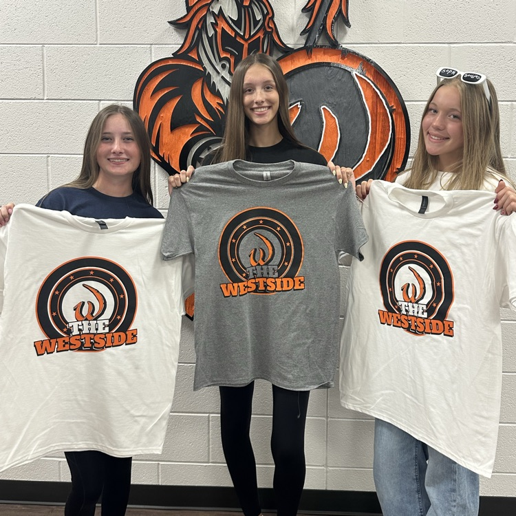 students holding shirts