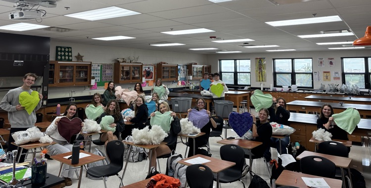 students with heart pillows